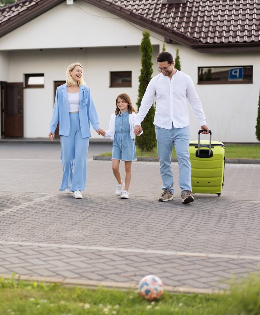 Happy Family Leaving Home With Luggage and Electric Car Charging